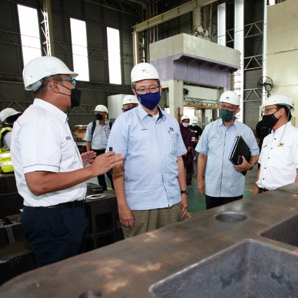 The delegation in hard hats on the factory floor at Miyazu (M) Sdn Bhd
